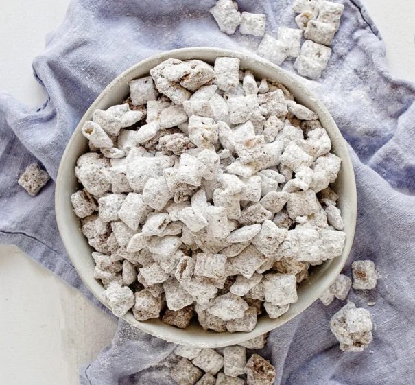 Puppy Chow is a snacking favorite that has been passed down for years in my family. It is a simple recipe that everyone absolutely loves! Using peanut butter, chocolate, and rice cereal you can create an easy, no fuss, handheld snack that everyone will rave about!