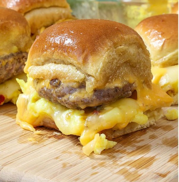 Cheesy Sausage and Egg Breakfast Sliders are a fully loaded perfectly portable hand held breakfast. All of your favorite breakfast fixin's come together with the most amazing and unexpected glaze to create the perfect Brinner (breakfast or dinner).