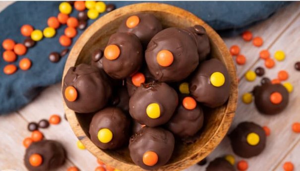 Reese’s Peanut Butter Oreo Truffles. Oreos, cream cheese, Reese’s Peanut Butter Cups and Reese’s Pieces together in a bite-size, chocolate dipped treat.