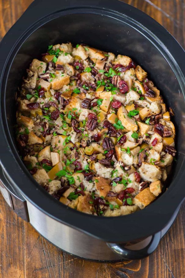 Best ever Crockpot Stuffing with apples and herbs! The slow cooker keeps the stuffing warm, frees up the oven and is great for a crowd.