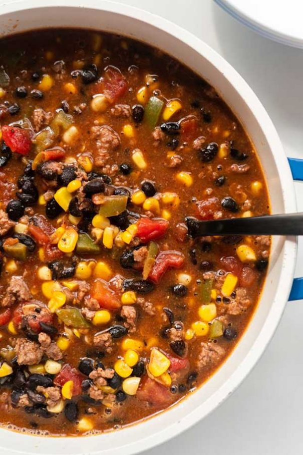 Easy Stovetop Taco Soup recipe, ready in 30 minutes. This soup is delicious, made with ground beef and other simple ingredients.