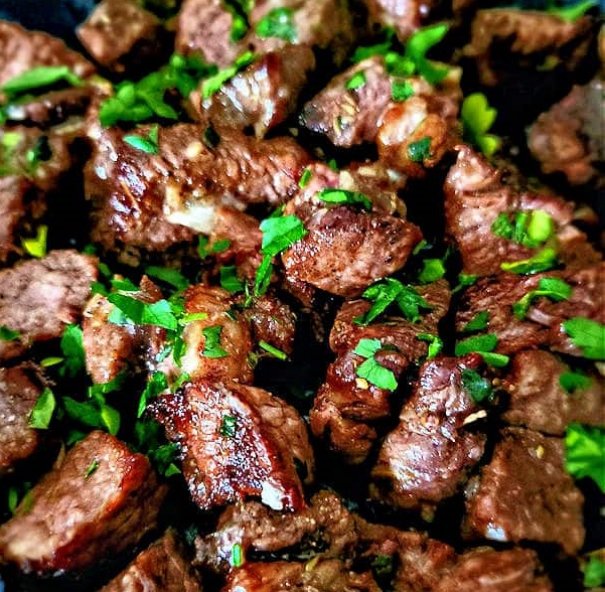 Air fryer steak bites have an appetizing caramelized crust, juicy tender interior, and are prepared in the air fryer in under 10 minutes. Then steak bites are tossed in garlic butter. Melt in your mouth delicious and easy to serve as a main entree or as party food.